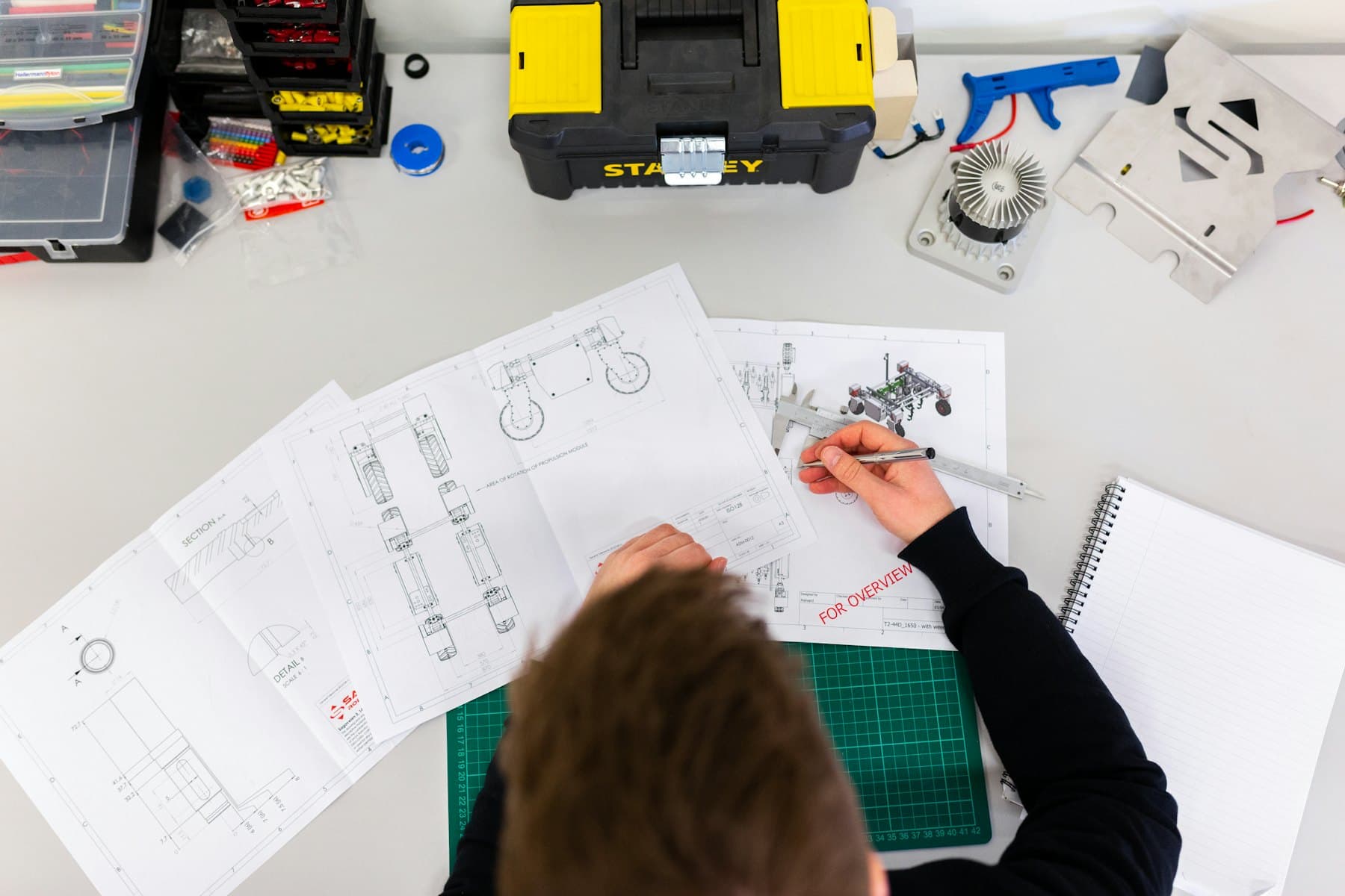 Engineer working on technical drawings